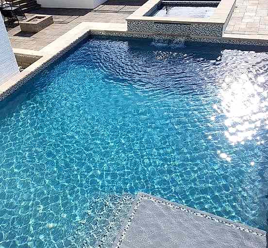 Kid with Broncos hat enjoying pool